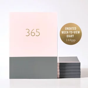 364 planner in pink. one third is a dusky pink colour at the top of the cover and the bottom third is a grey colour. Gold foil writing "365" gives this a luxury feel