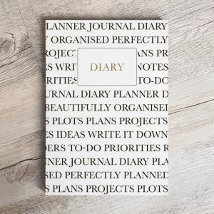 diary planner laid on surface showing the front cover covered in words such as perfectly planner, projects, organised