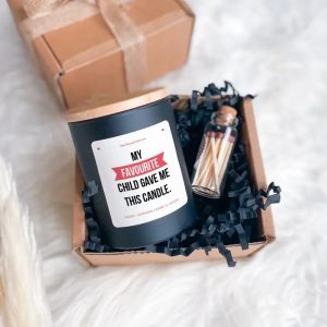 my favourite child scented gift set shown here laid down in the box with the glass jar of matches next to it.