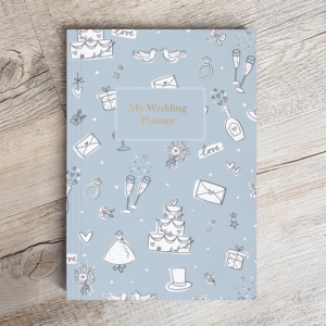 Wedding planner cover in pale blue with wedding motifs scattered. Wedding cake, champagne flutes, wedding dress etc