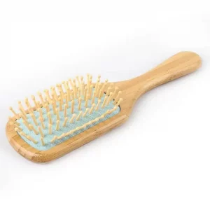 Bamboo hair brush. The main body is natural bamboo/wood coloured. This is a long handled paddle type brush. The cushion part of the brush is Blue with natural coloured bristles. Ideal for brushing all hair types.