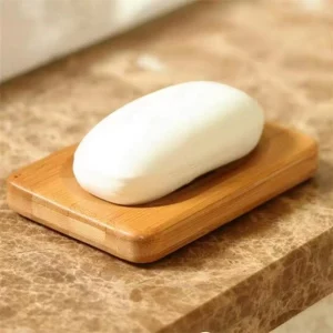 Bamboo Soap dish showing a bar of soap sitting atop of it.