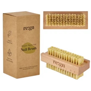 Natural bamboo nail brush sat next to a brown kraft card box