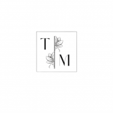 A square box with the letters T and M. A line between the letters with floral graphics either side.
